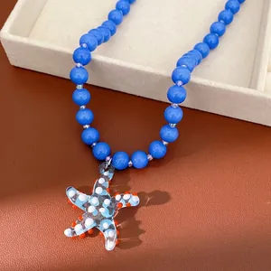 Handmade blue beaded necklace featuring a decorative glass starfish pendant charm