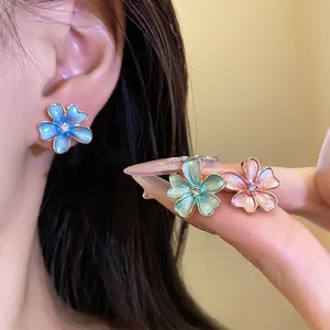 Elegant painted zircon flower stud earrings set in vibrant blue, pink and green colors.