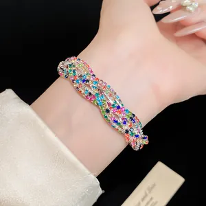Detailed close-up of a multi-layer wrap bracelet with colorful rhinestones on a wrist.