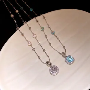 Elegant pearl and zircon beaded necklaces displayed on a decorative textured cream plate