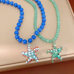 Macro detail of vibrant blue and mint green glass bead necklaces with starfish pendants