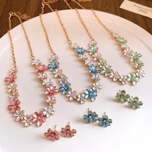 Detail view of colorful spray-painted flower necklaces and matching stud earrings set