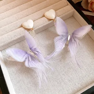 Elegant purple fabric butterfly earrings with heart studs in a display box