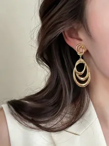 Elegant golden multi-layer circular drop earrings with a minimalist luxury style for women
