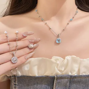 Detailed view of elegant pearl beaded necklace with blue zircon and star motif pendants