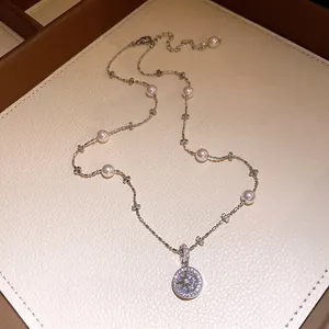 Close-up of pearl beaded necklace with a shimmering zircon star pendant