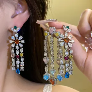 Macro view of colorful zircon flower earrings with sparkling waterdrop tassels.