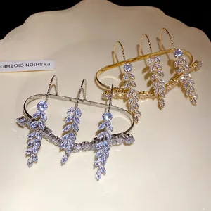 Detailed view of elegant wheat ear zircon rings in silver and gold luxury finishes