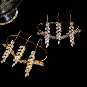 Macro shot of gold and silver wheat-ear rings with sparkling cubic zirconia stones.
