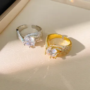 Close-up detail of elegant twisted open rings with sparkling round cut zircon center stone