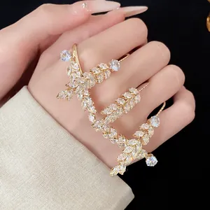Exquisite zircon wheat ear ring on hand, showcasing elegant and high-end design.
