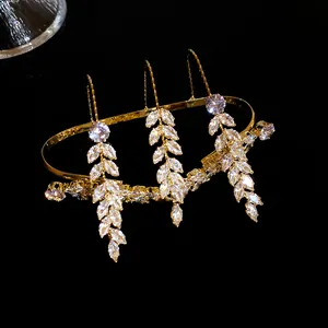 Macro view of gold-tone hand jewelry featuring marquise-cut zircon wheat ear drops