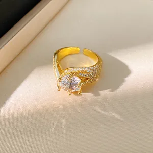 Macro detail of an elegant gold twisted open ring featuring a large sparkling zirconia