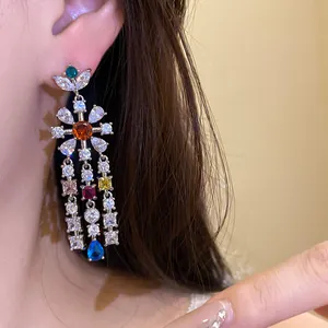 Close-up of zircon flower tassel earrings worn on ear, highlighting delicate colorful stones