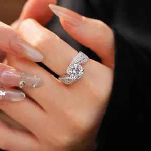 Close-up macro detail of a sparkling zircon ring with a unique twisted band design on a finger