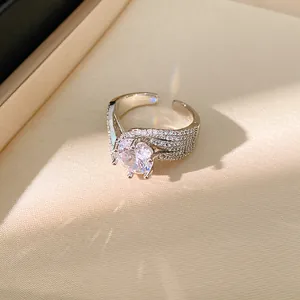 Detail of silver twisted ring with zircon, showing micro-pave stones and light refraction.