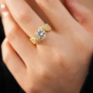 Close-up of a gold-plated twisted ring set with a large sparkling round zircon.