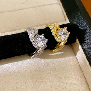 Close-up of twisted zircon rings in silver and gold, highlighting sparkling pavé details.