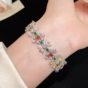 Close-up view of a colorful zircon flower bracelet worn on a female wrist detail