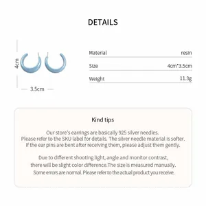 Detail view of light blue C-shaped resin earrings with 4cm size measurement labels