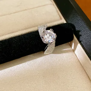 Close-up of twisted silver open ring with a large round cubic zirconia stone.