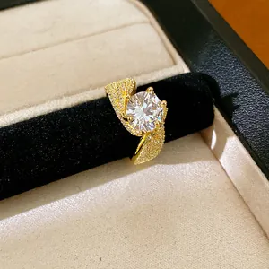 Detailed close-up view of a gold twisted ring featuring a brilliant round zircon stone.