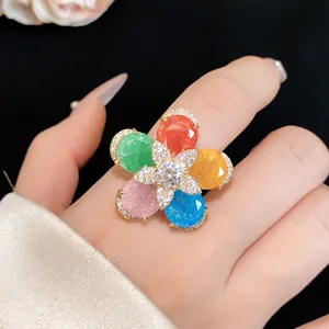 Detailed view of a vibrant colorful flower ring with glittering petals and zircon