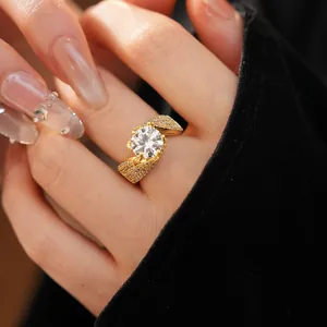 Detailed macro view of a gold-plated twisted ring set with a brilliant round zirconia.