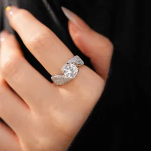 Detailed view of an elegant twisted silver ring featuring a large central zircon and pavé stones.