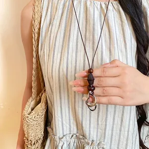 Retro ethnic style long necklace with round wood beads and a stylish resin pendant