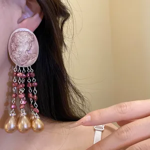Elegant vintage cameo oval stud earrings with dangling pink and champagne gold pearl tassels