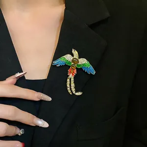 Vintage enamel and rhinestone bird brooch pinned on a black blazer jacket