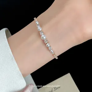 Elegant 18k gold plated bracelet featuring pearls and sparkling cubic zirconia stones