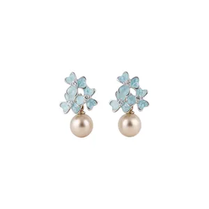Elegant silver-tone flower stud earrings with blue enamel petals and a champagne pearl drop