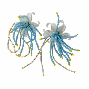 Elegant white lily flower earrings with long blue and yellow beaded tassels for vacation