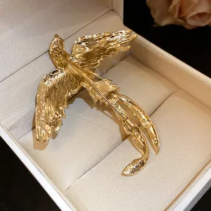 Detailed back view of a vintage gold bird brooch featuring a textured metallic finish