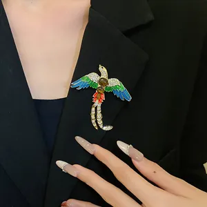 Vintage bird brooch with enamel wings and crystals pinned on a black blazer lapel