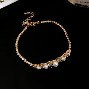 Detailed macro view of 18k gold plated bracelet with pearls and sparkling zircons
