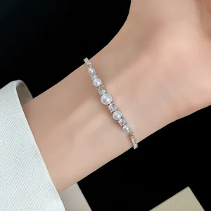 Close-up of elegant 18k gold plated bracelet featuring white pearls and zircon stones
