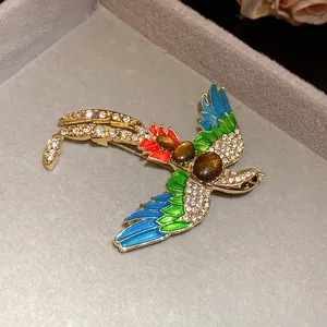 Close-up of vintage bird brooch with colorful enamel and sparkling rhinestones