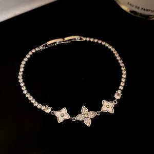 Close-up of 18k gold plated zircon flower bracelet with elegant sparkling stones.
