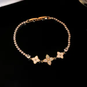 Detailed macro view of 18k gold plated bracelet featuring zircon-encrusted flower charms