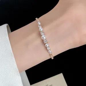 Detail of 18k gold plated bracelet with pearls and sparkling cubic zirconia stones