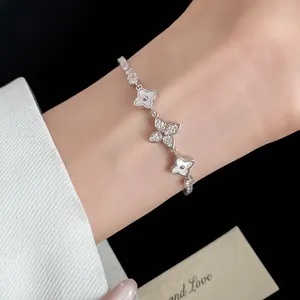 Close-up detail of exquisite 18k gold plated flower bracelet with sparkling zircons on wrist
