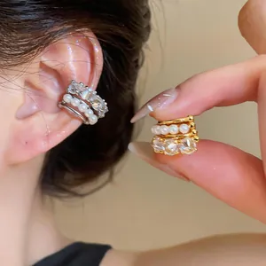 Detail view of multi-layer zircon and pearl ear cuff for non-pierced ears.
