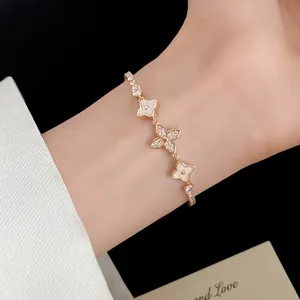 Close-up detail of 18k gold plated flower bracelet with zircons on model wrist