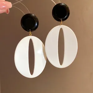 Retro resin oval drop earrings in black and white minimalist style with silver needles