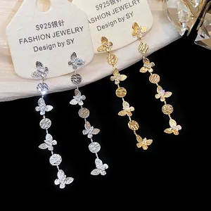 Detail macro view of 18k gold plated butterfly tassel earrings with sparkling zircons