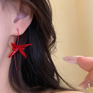 Elegant red spray-painted floral metal drop earrings for a vintage minimalist look.