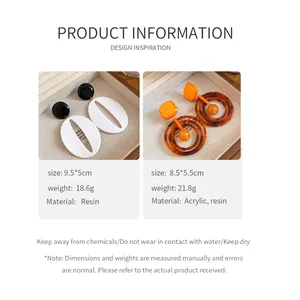 Macro detail of resin oval and acrylic geometric earrings with size and weight info